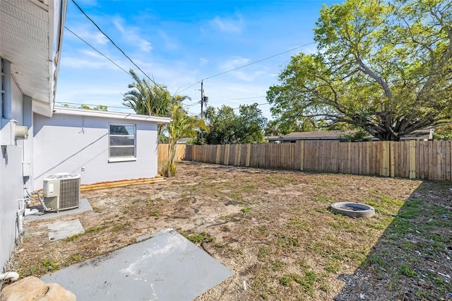 view of yard featuring central AC unit and a fenced backyard