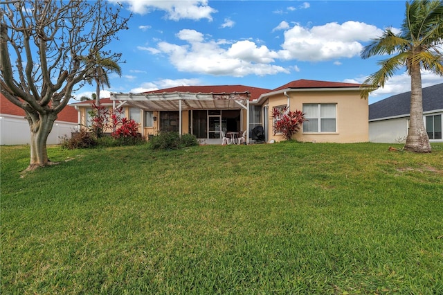 back of property featuring a lawn and stucco siding