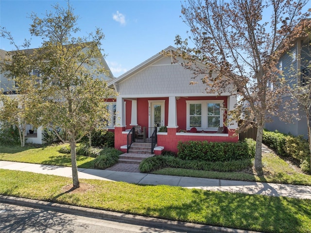 view of front of house with concrete block siding and a front yard