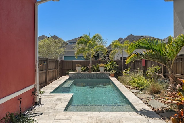 view of pool featuring a patio area, a fenced backyard, and a fenced in pool