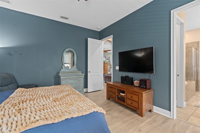 bedroom featuring connected bathroom, wood finished floors, visible vents, and baseboards