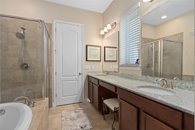 full bath with tile patterned flooring, double vanity, a stall shower, a bath, and a sink