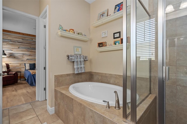 ensuite bathroom with tile patterned flooring, ensuite bath, a garden tub, and a stall shower