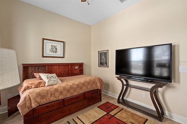 bedroom with ceiling fan, baseboards, and wood finished floors