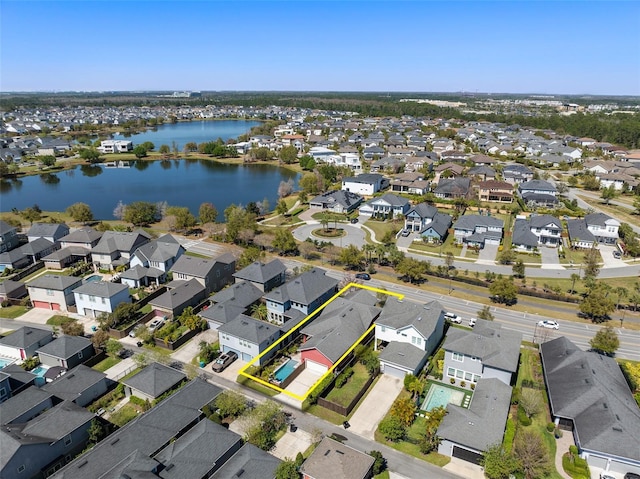 drone / aerial view with a water view and a residential view