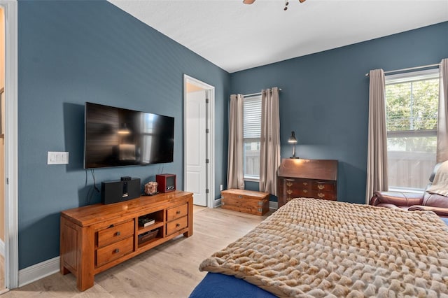 bedroom with ceiling fan, baseboards, and wood finished floors