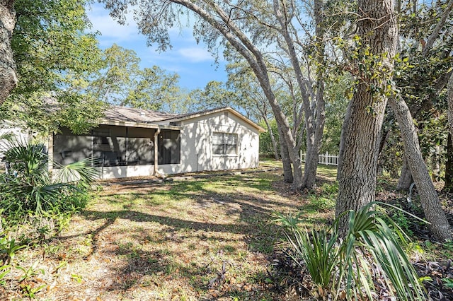 view of yard with fence and a sunroom