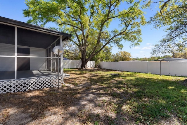 view of yard with a fenced backyard and a sunroom