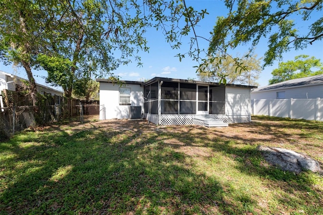 back of house with a yard, central AC unit, a fenced backyard, and a sunroom