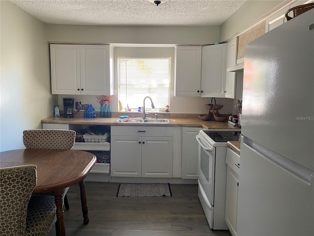 kitchen featuring a sink, white appliances, dark wood-type flooring, and white cabinetry