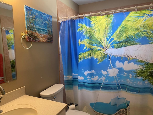 full bathroom featuring toilet, vanity, and a shower with curtain