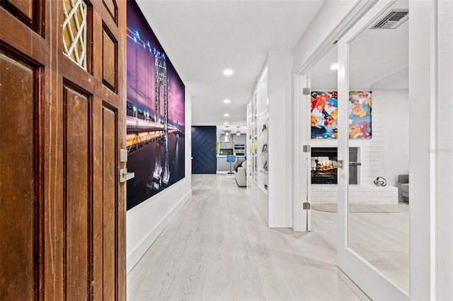 hallway featuring recessed lighting, visible vents, and light wood-style flooring