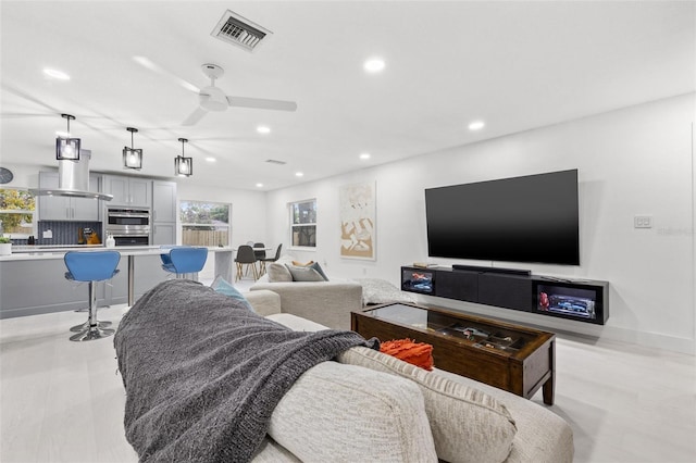 living room with visible vents, recessed lighting, and a ceiling fan