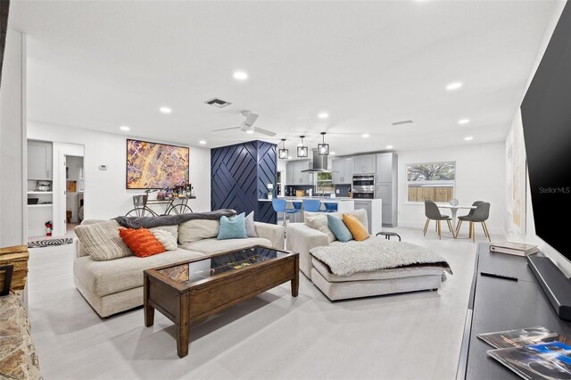 living room featuring recessed lighting and visible vents