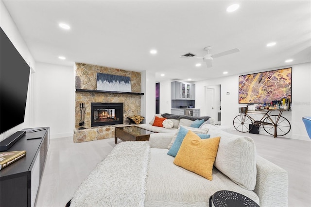 living room featuring a ceiling fan, wood finished floors, recessed lighting, a fireplace, and baseboards