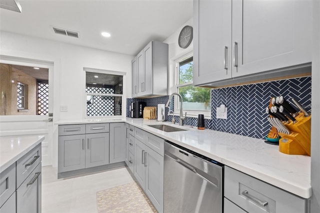 kitchen with visible vents, gray cabinetry, and stainless steel dishwasher