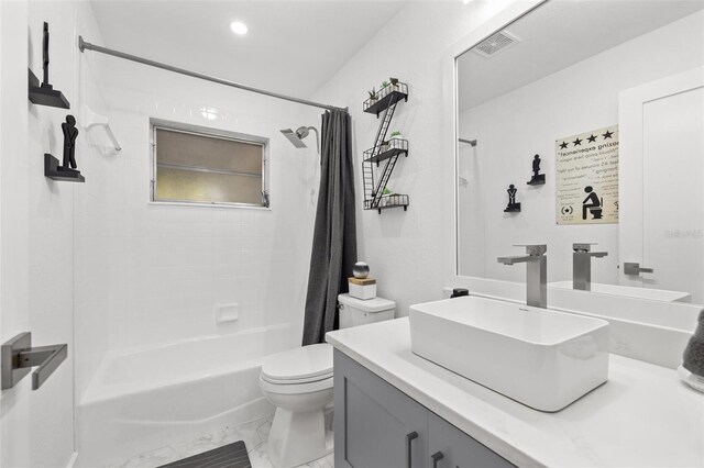 full bathroom with visible vents, toilet, shower / bath combo, marble finish floor, and vanity