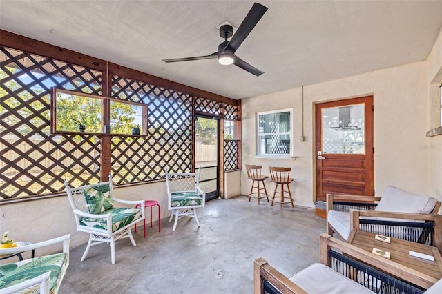 unfurnished sunroom featuring a ceiling fan