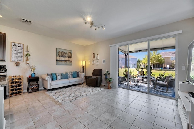 living room with light tile patterned floors and visible vents