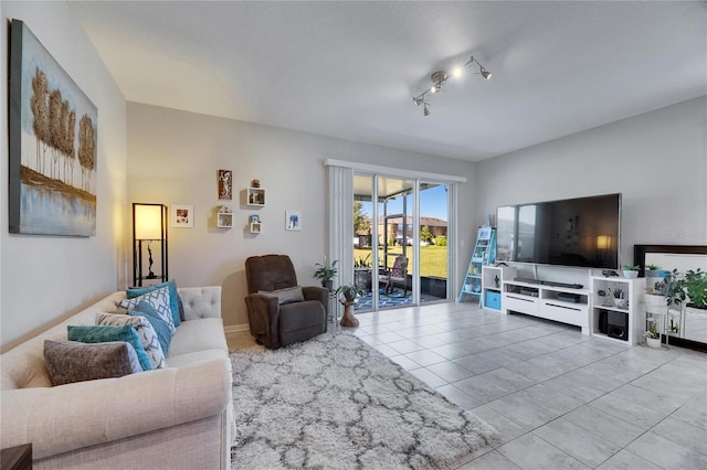 living room with tile patterned floors and rail lighting