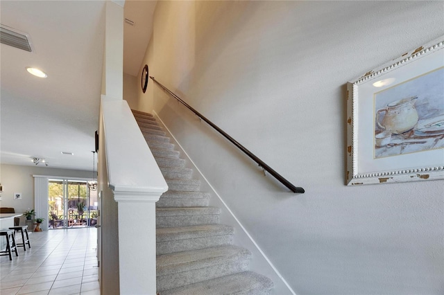 staircase featuring tile patterned flooring, visible vents, and recessed lighting