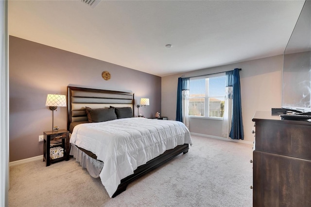 bedroom with baseboards and light carpet