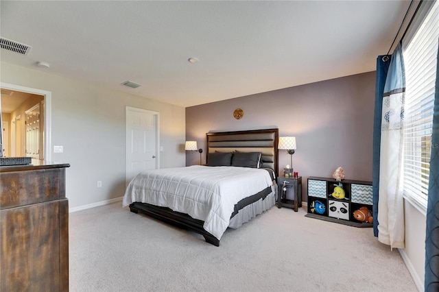 carpeted bedroom with baseboards and visible vents