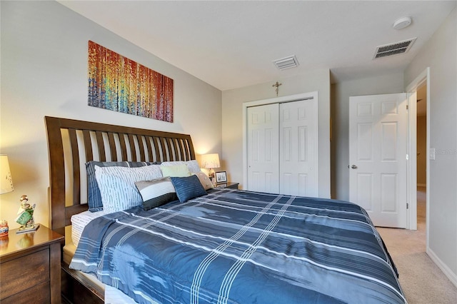 carpeted bedroom with a closet, visible vents, and baseboards