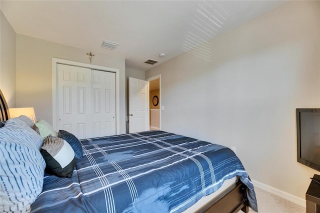 bedroom with visible vents, baseboards, a closet, and carpet floors