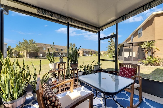 sunroom / solarium featuring a residential view