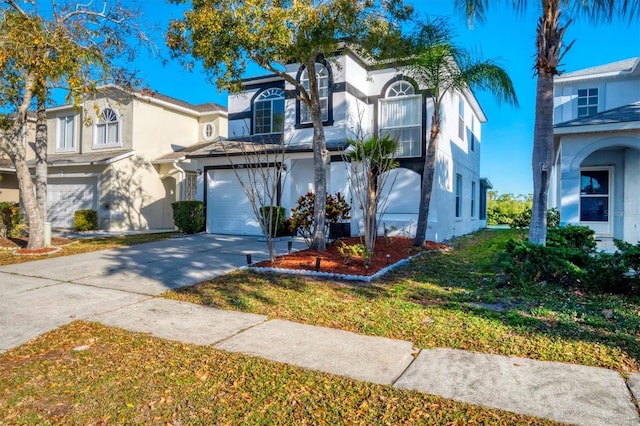 view of front of house featuring stucco siding, an attached garage, and driveway