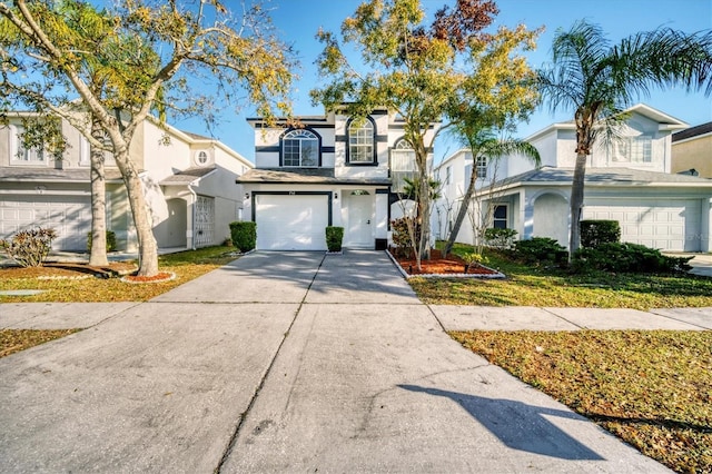 view of front of property featuring an attached garage, driveway, and stucco siding