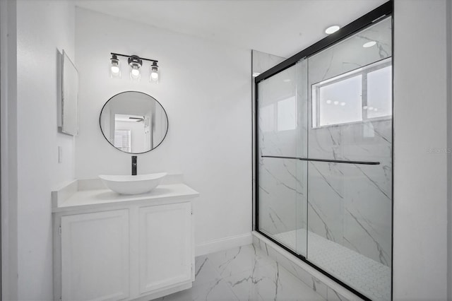 full bathroom with vanity, baseboards, marble finish floor, and a marble finish shower