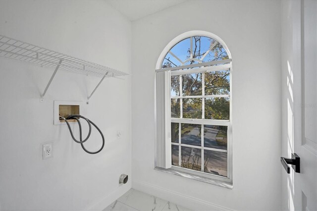 washroom with baseboards, washer hookup, laundry area, marble finish floor, and hookup for an electric dryer