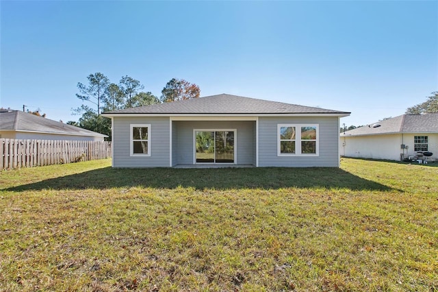 back of house with a yard and fence