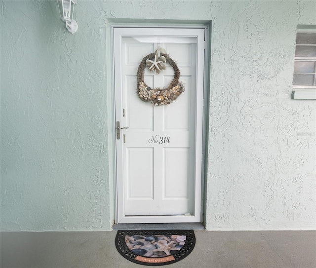 property entrance featuring stucco siding