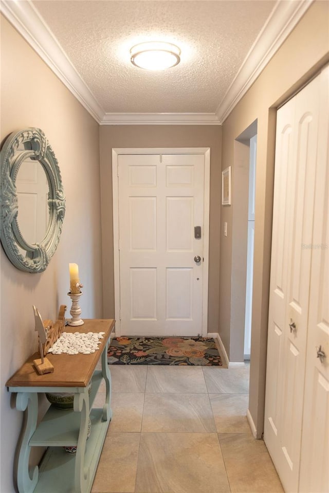 entryway with a textured ceiling, baseboards, and ornamental molding