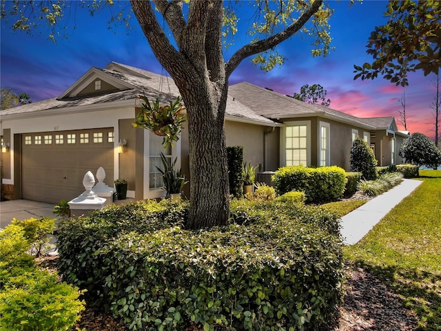 single story home with an attached garage and stucco siding