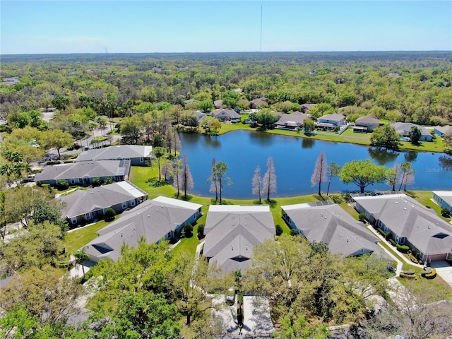 birds eye view of property featuring a view of trees, a residential view, and a water view