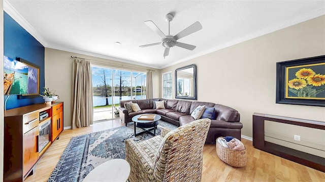 living area with light wood-style flooring, a textured ceiling, crown molding, and a ceiling fan