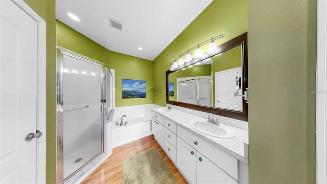 bathroom featuring a sink, a bath, and a shower stall