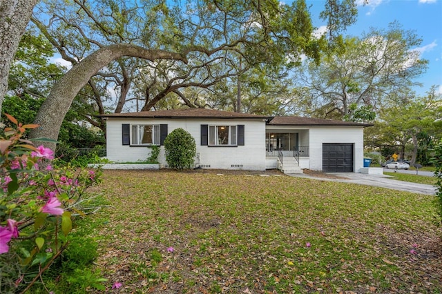 ranch-style house with an attached garage, a front lawn, concrete driveway, crawl space, and brick siding