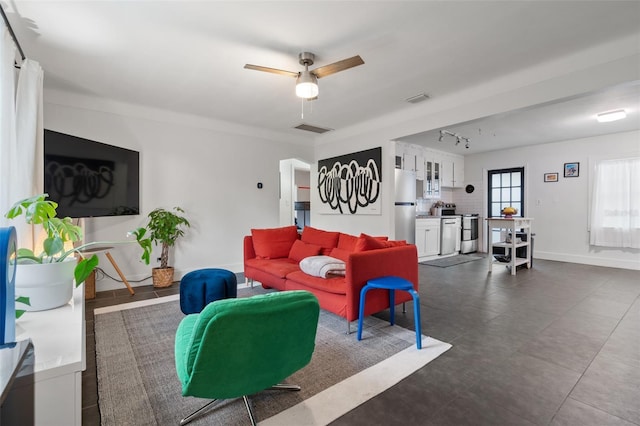 living area with rail lighting, baseboards, visible vents, and ceiling fan