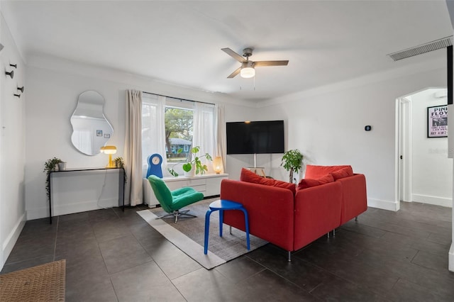 living room with visible vents, baseboards, and ceiling fan