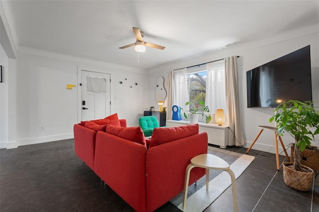 living room featuring a ceiling fan and baseboards