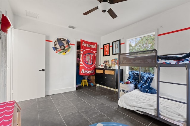 bedroom featuring tile patterned flooring, visible vents, and a ceiling fan