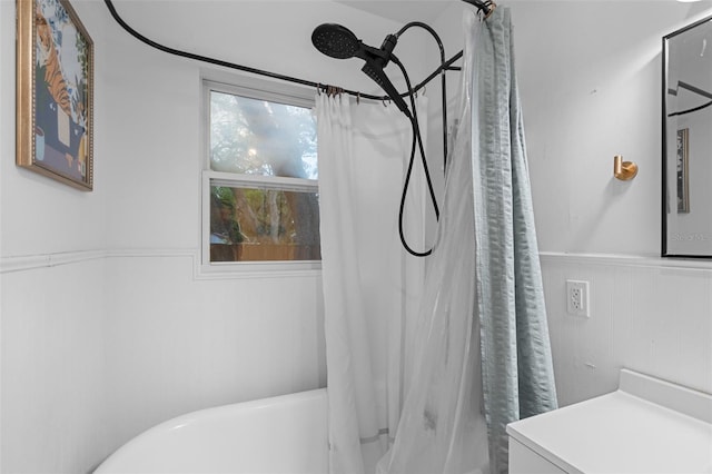 full bath featuring shower / bathtub combination with curtain and a wainscoted wall