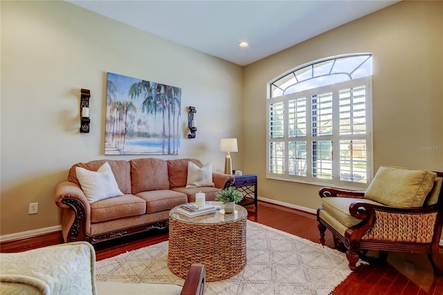 living room with recessed lighting, wood finished floors, baseboards, and a healthy amount of sunlight