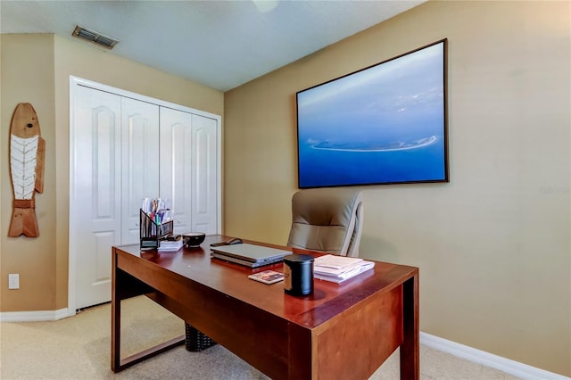 carpeted office with visible vents and baseboards