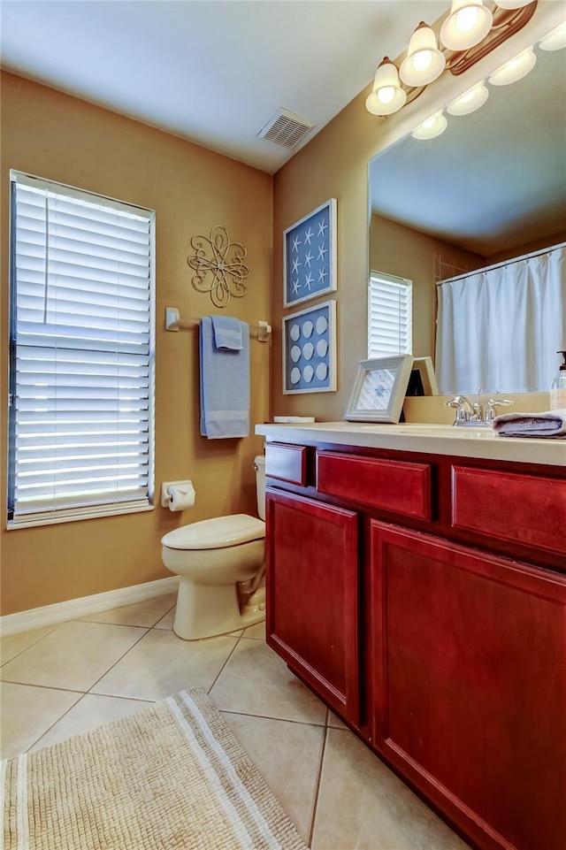 bathroom featuring visible vents, baseboards, toilet, tile patterned floors, and vanity